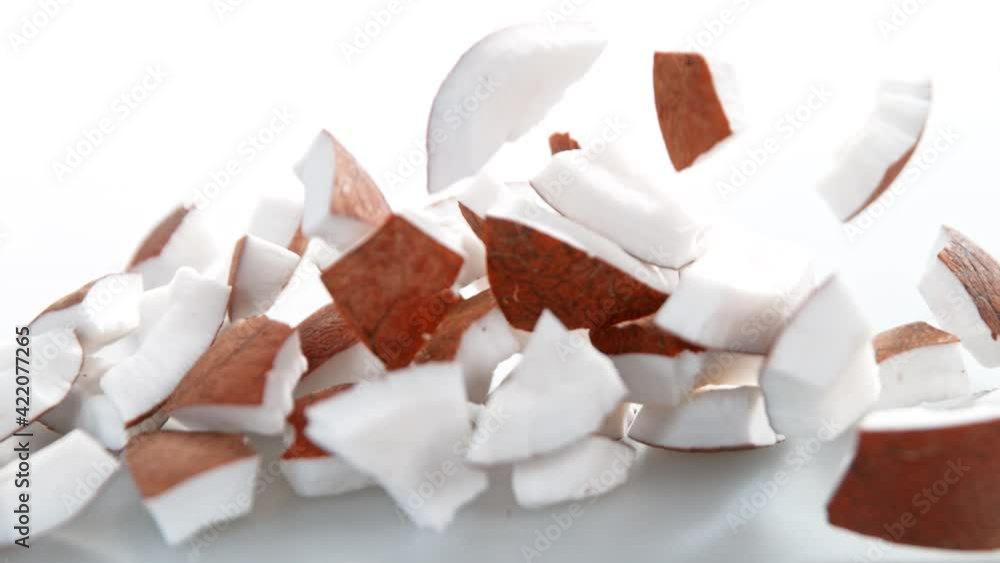 Super Slow Motion Shot of Fresh Coconut Pieces Falling on White Background at 1000fps. Super Slow Motion Shot of Fresh Coconut Pieces Falling on White Background at 1000fps.