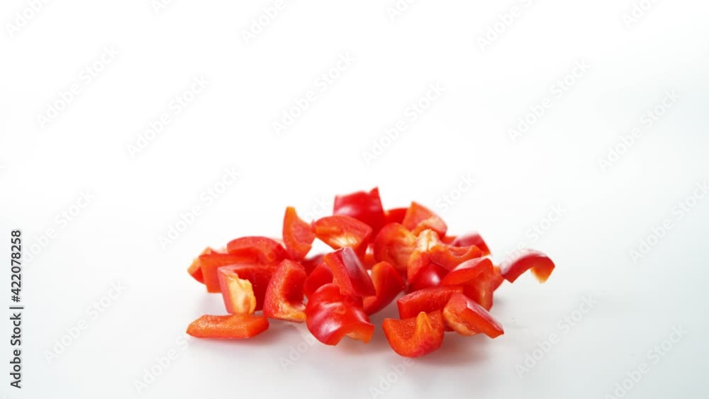 Super Slow Motion Shot of Falling and Slicing Red Pepper on White Background at 1000fps. Super Slow Motion Shot of Falling and Slicing Red Pepper on White Background at 1000fps.