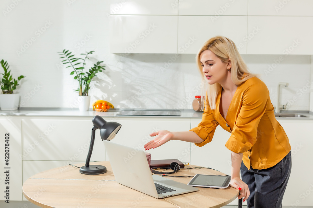 Remote working from home. Young woman using laptop. Freelancer workplace in kitchen office. Teleworking in isolation, female business, shopping online. Student in distance learning. Lifestyle moment. Remote working from home. Young woman using laptop. Freelancer workplace in kitchen office. Teleworking in isolation, female business, shopping online. Student in distance learning. Lifestyle moment.