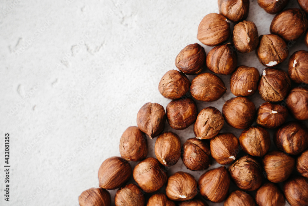 Obraz premium sprinkled hazelnuts on a white background