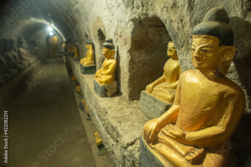 a golden Buddha statue was in the tunnel line at temple area  Mrauk U Myanmar