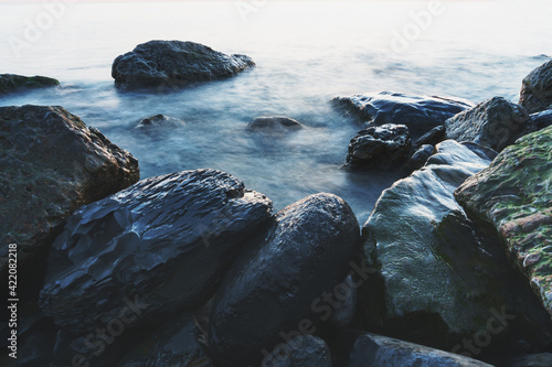 Sea water washing the rocks on the coast.