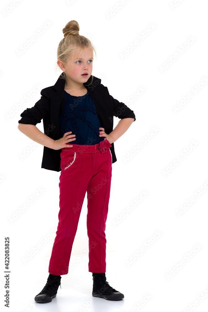Stylish girl standing with hands on her waist Stylish girl standing with hands on her waist