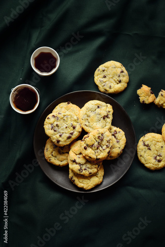 Delicious chocolate chips cookies on plate top view