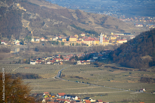 A view from Weißenkirchen over vineyards and Dürnstein ruins in the early spring on a sunny day from above