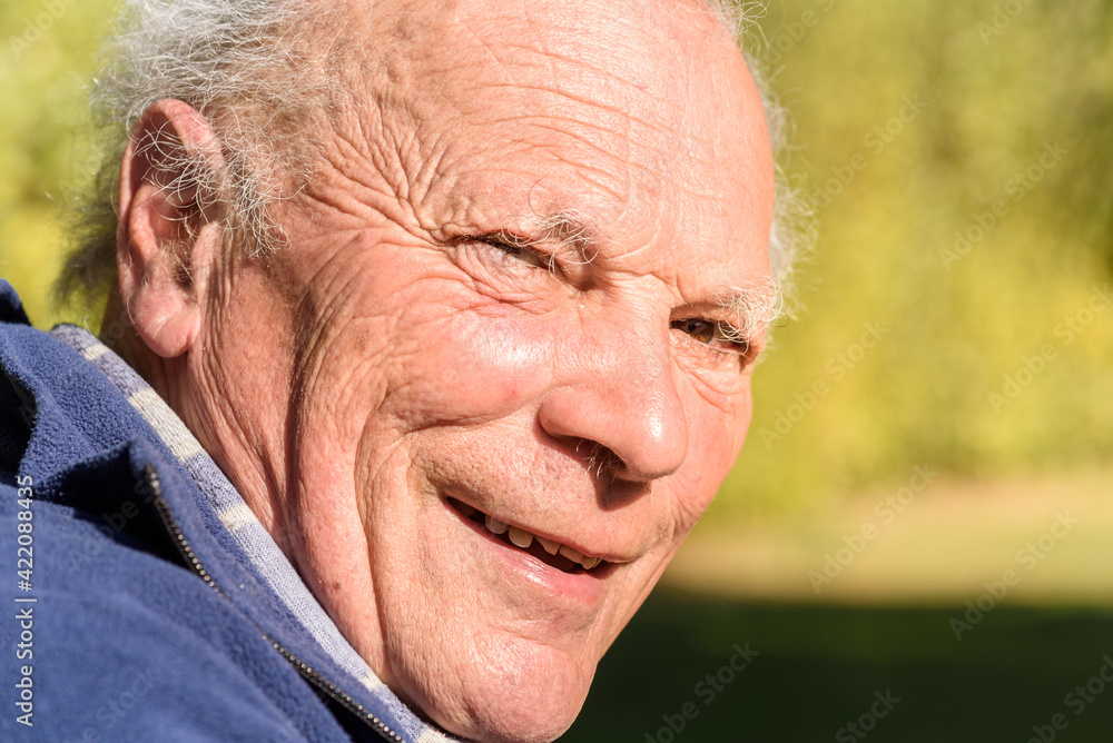 Portrait of smiling Senior man in the garden at sunny day. Portrait of smiling Senior man in the garden at sunny day.