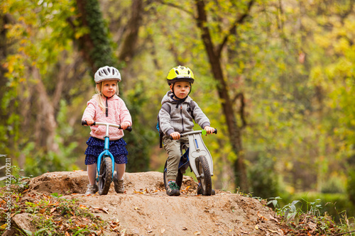 Two little friends sitting on balancing bikes © oksix
