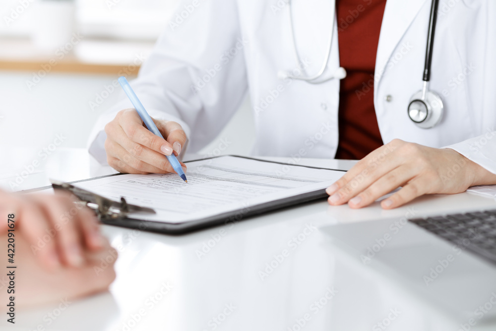 Unknown woman-doctor consulting patient and using clipboard with a medication history record. Medicine concept Unknown woman-doctor consulting patient and using clipboard with a medication history record. Medicine concept
