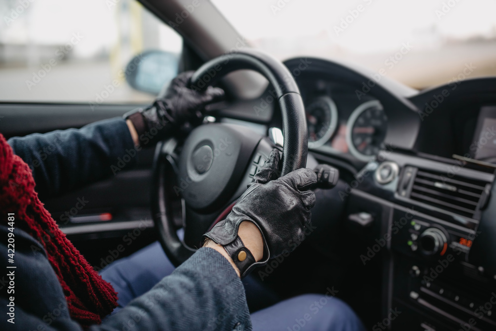 automotive leather gloves, driver's hands on the steering wheel.