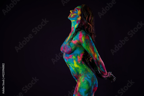 Schilderij op canvas Bright colorful body art on black background, sexy nude woman painted with powde