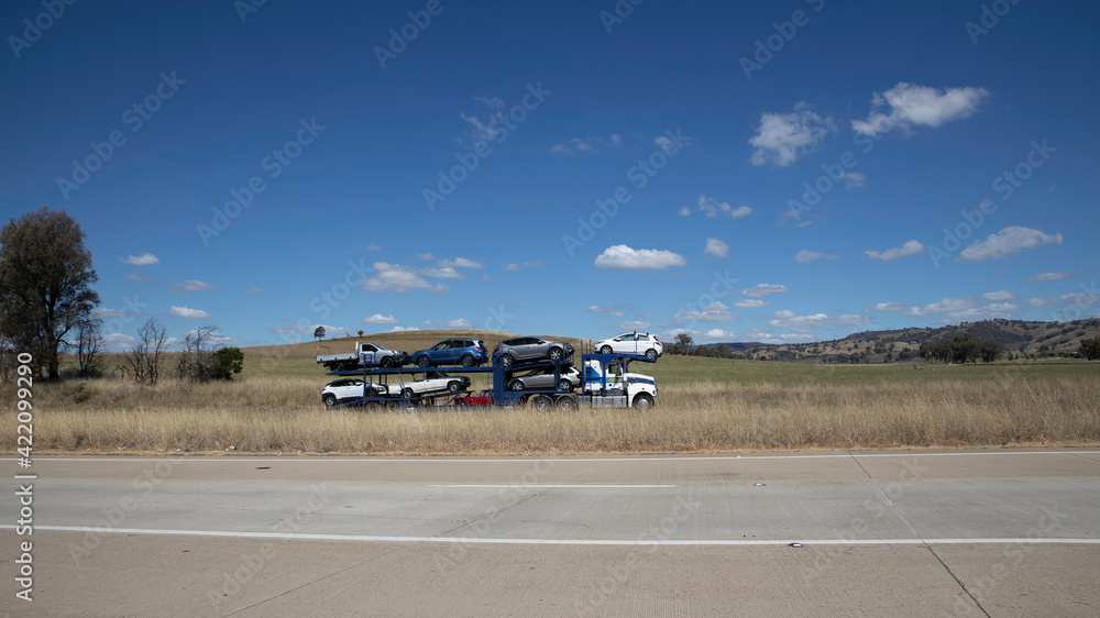 A freeway in an Australian Country Town midway between Sydney and Melbourne with nice blue sky and lush green trees as a backdrop A freeway in an Australian Country Town midway between Sydney and Melbourne with nice blue sky and lush green trees as a backdrop