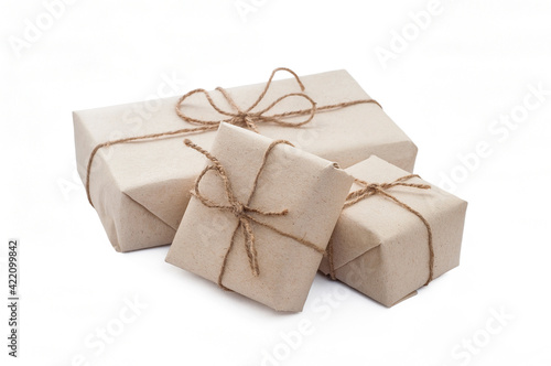 isolated eco friendly packaging gifts in kraft paper on a white background, eco decor. Gift boxes wrapped