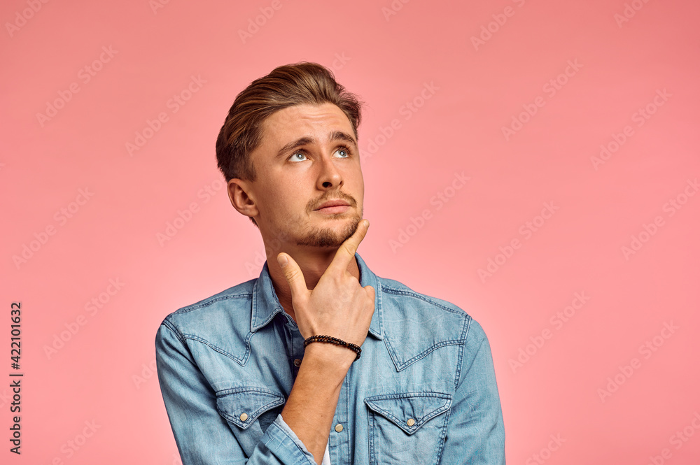 Fototapeta premium Pensive man portrait, pink background, emotion