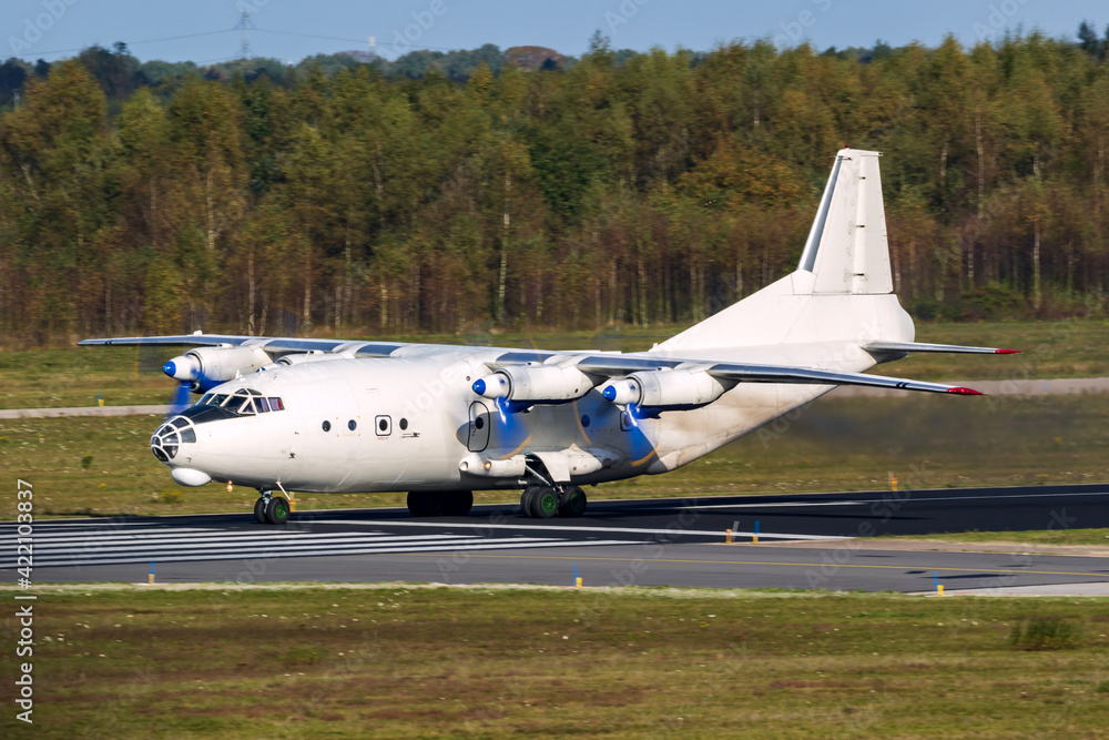 Old cargo airplane taking off with turboprop engine smoke emission. Old cargo airplane taking off with turboprop engine smoke emission.