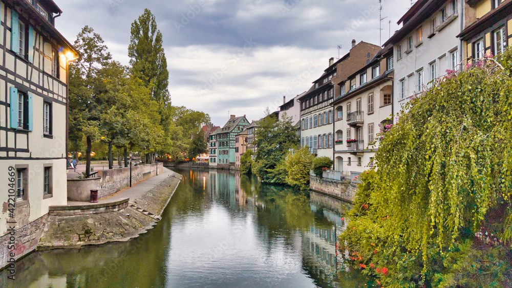 View of the old buildings on the riverbanks reflecting on the water, Petite France Strasbourg
