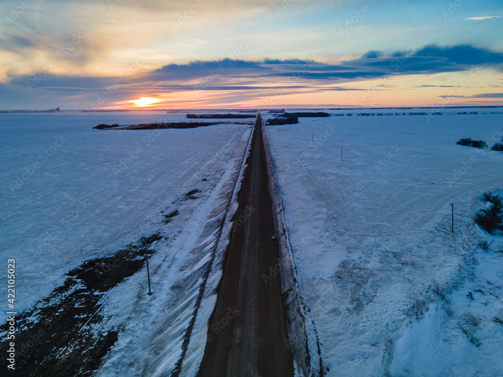A beautiful view of the sun setting in a rural area of the prairie province of Saskatchewan in the winter
