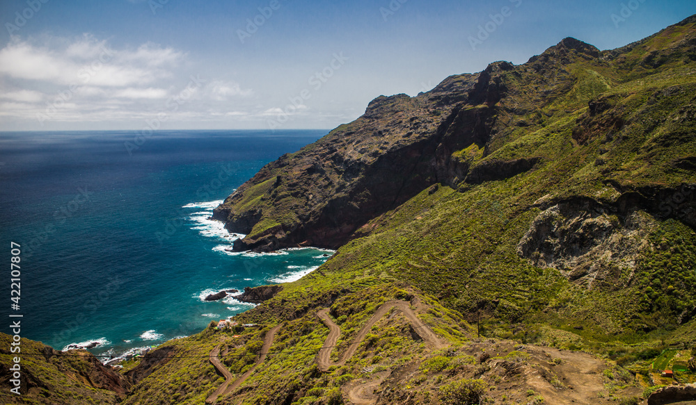Hiking trail descending down to ocean and dramatic cliffs of Anaga mountains in Tenerife