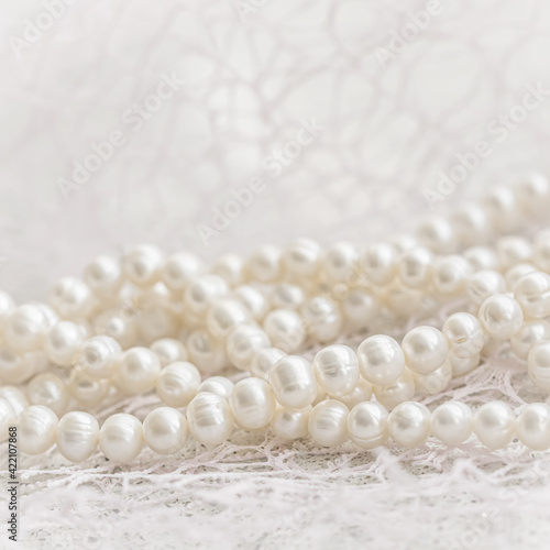 Nature white string of pearls in soft focus, with highlights.