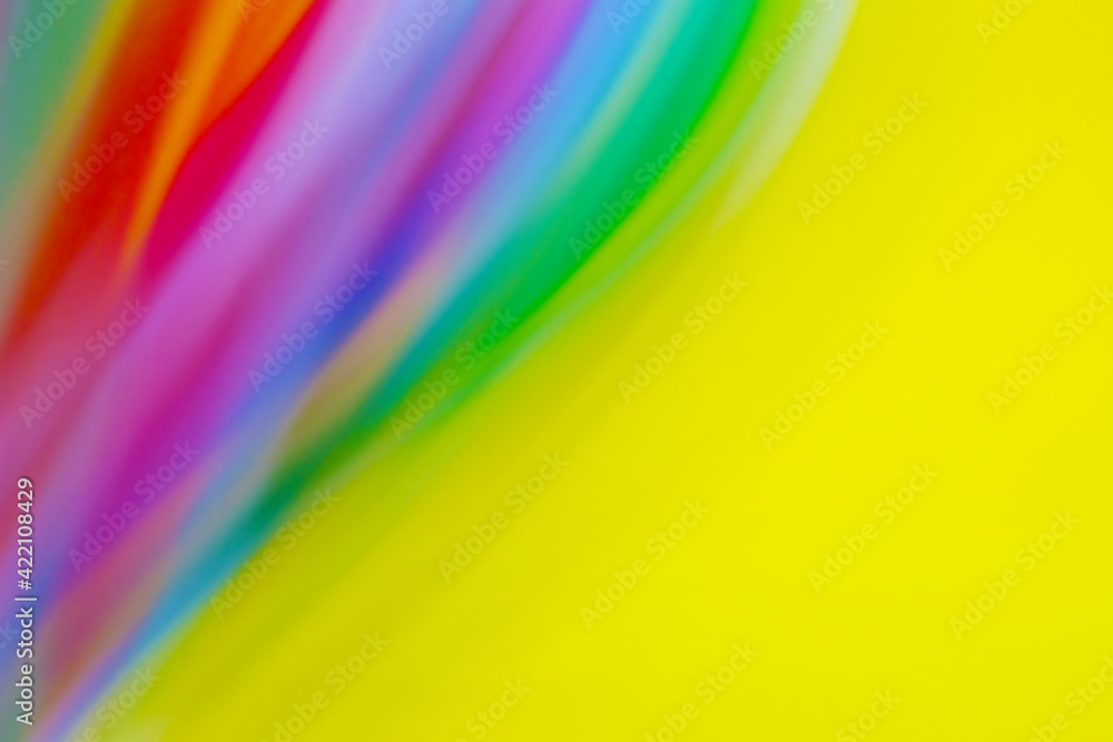 Obraz premium Yellow background with multicolored wavy stripes