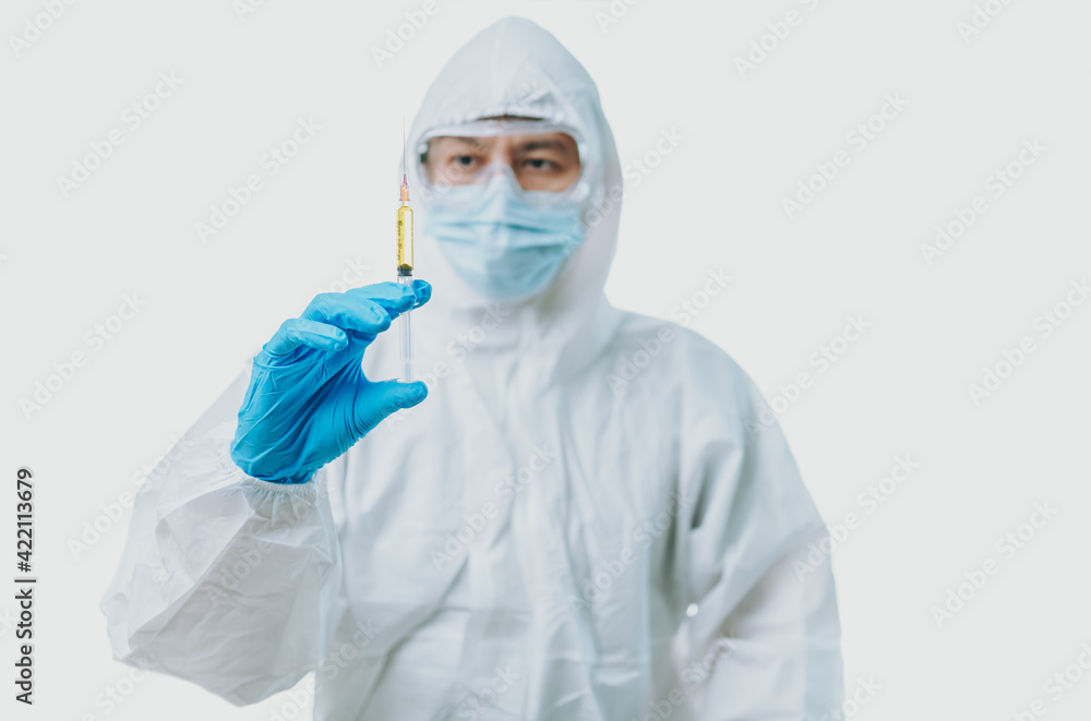 The doctor hold syringe and wearing medical gloves, personal protective equipment or ppe, mask, goggle and suit to protect COVID-19 infection. coronavirus, medical, healthcare concept The doctor hold syringe and wearing medical gloves, personal protective equipment or ppe, mask, goggle and suit to protect COVID-19 infection. coronavirus, medical, healthcare concept