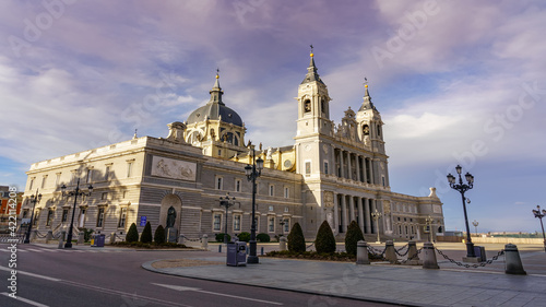 Almudena Cathedral in Madrid on its main facade on sunny day at sunrise.