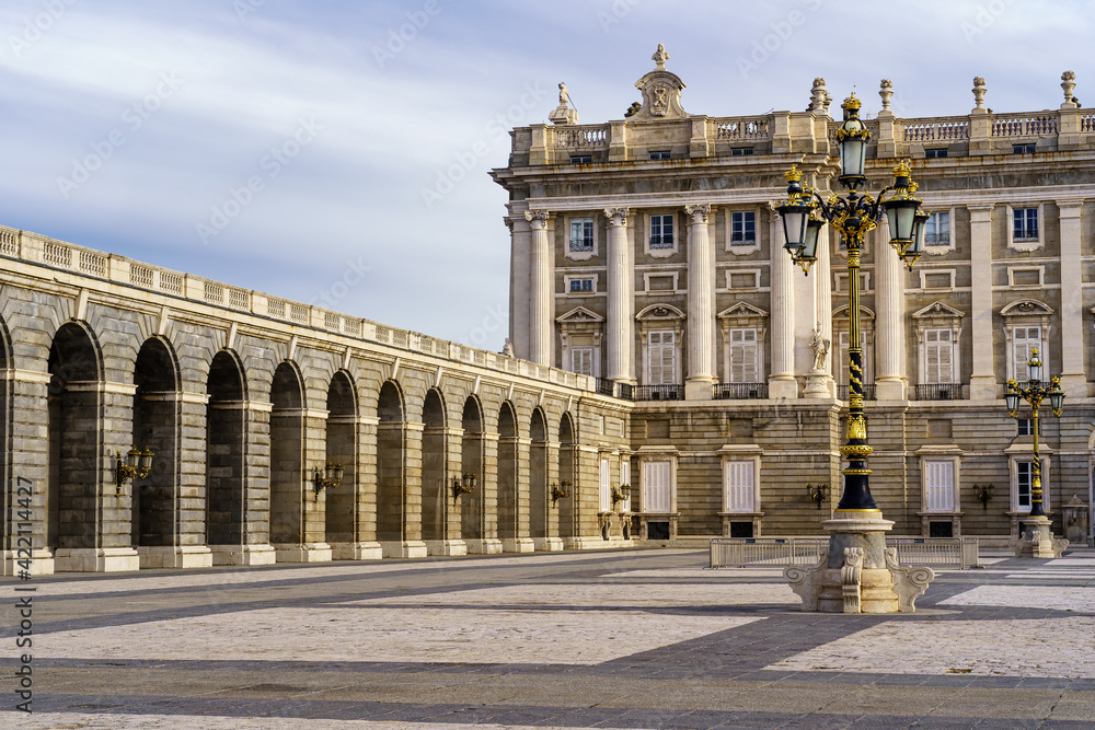 Detail of the outer courtyard of the royal palace of Madrid, with lampposts, arches and neoclassical style.