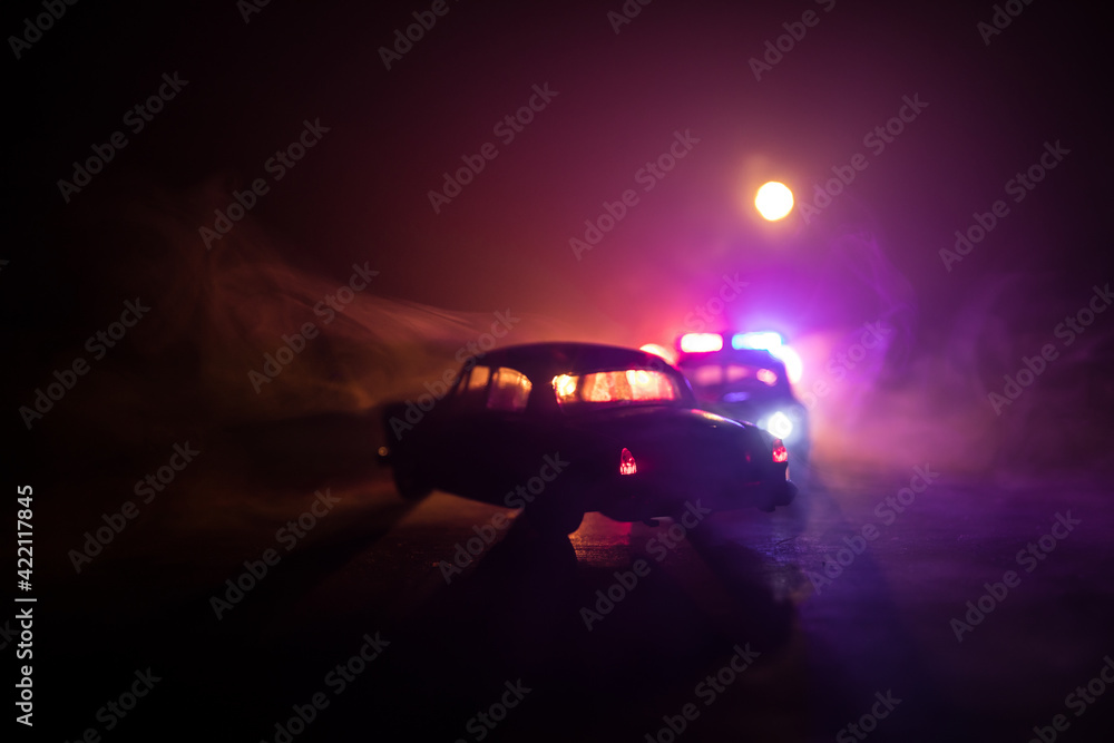 Police car chasing a car at night with fog background. 911 Emergency response police car speeding to scene of crime. Police car chasing a car at night with fog background. 911 Emergency response police car speeding to scene of crime.