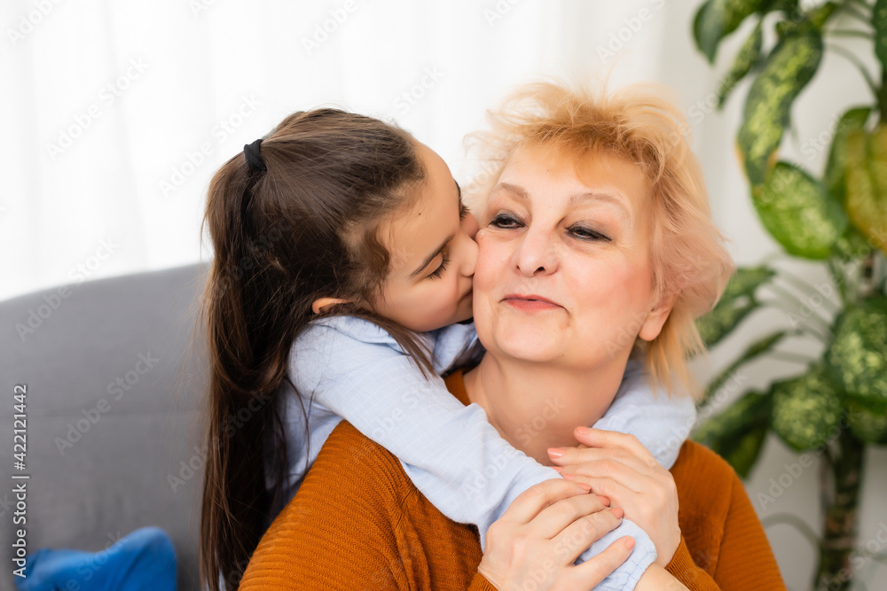 Lovely little girl with her grandmother looking at the camera Lovely little girl with her grandmother looking at the camera