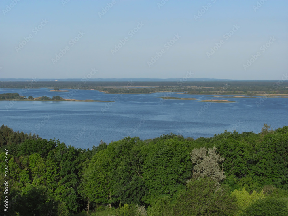 landscape background: green forest, river with islands and blue sky landscape background: green forest, river with islands and blue sky