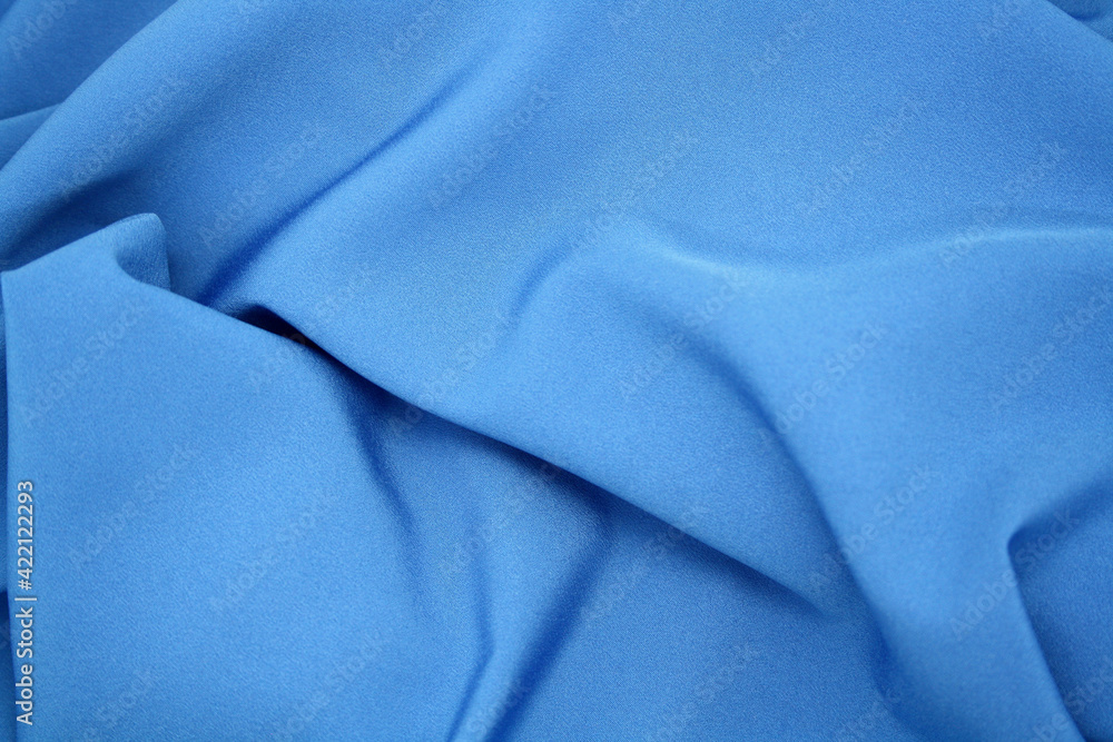 The background is made of synthetic fabric lying in waves. The background is made of synthetic fabric lying in waves.