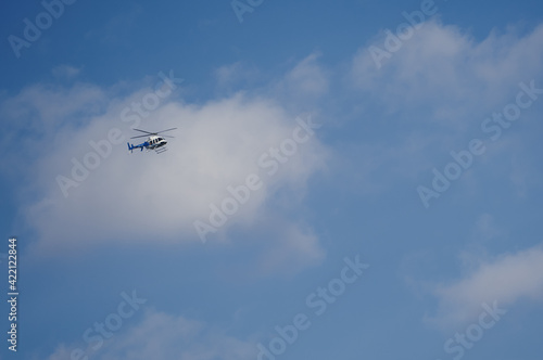 Helicopter against a bluaerial, propeller, power, speed, white, copter, technology, machine, high, clouds, sky, helicopter, blue, fly, air, chopper, flight, landing, plane, travel, ae sky with clouds.
