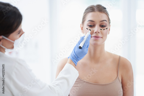 Plastic surgeon consulting a female patient