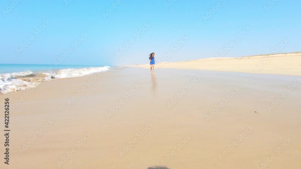4k video of Young Indian Woman Run care Free with Barefoot On Empty Beach. Sandy beach with blue sky in summer 4k video of Young Indian Woman Run care Free with Barefoot On Empty Beach. Sandy beach with blue sky in summer