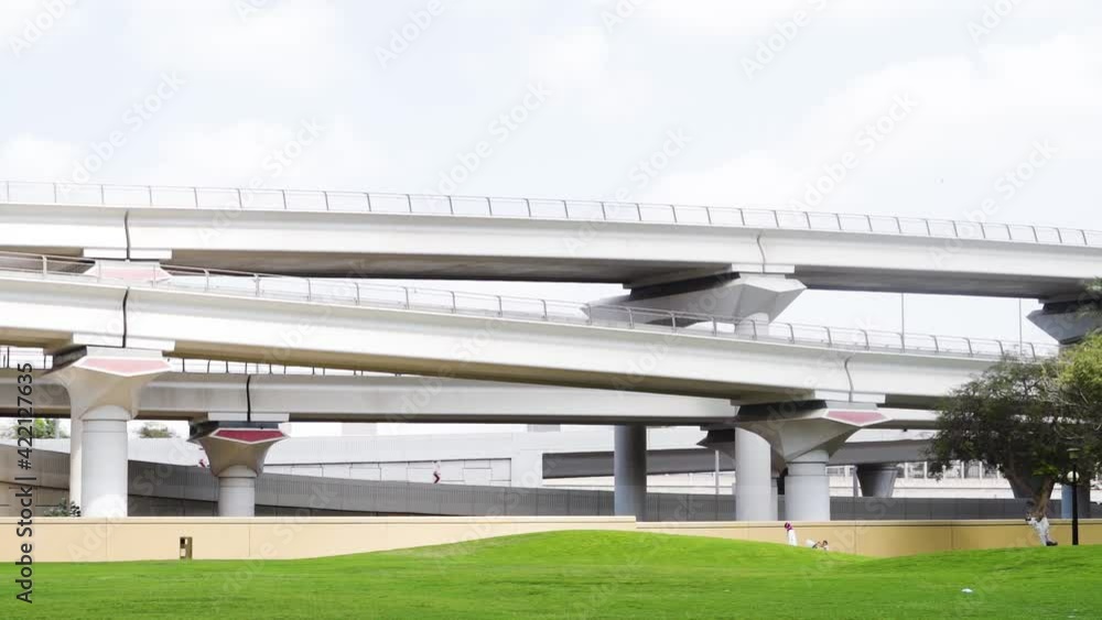 Lofty Archways Of Dubai Metro Train From Al Rashidiya Park With People Strolling At Daytime In Dubai. - Static Shot Lofty Archways Of Dubai Metro Train From Al Rashidiya Park With People Strolling At Daytime In Dubai. - Static Shot