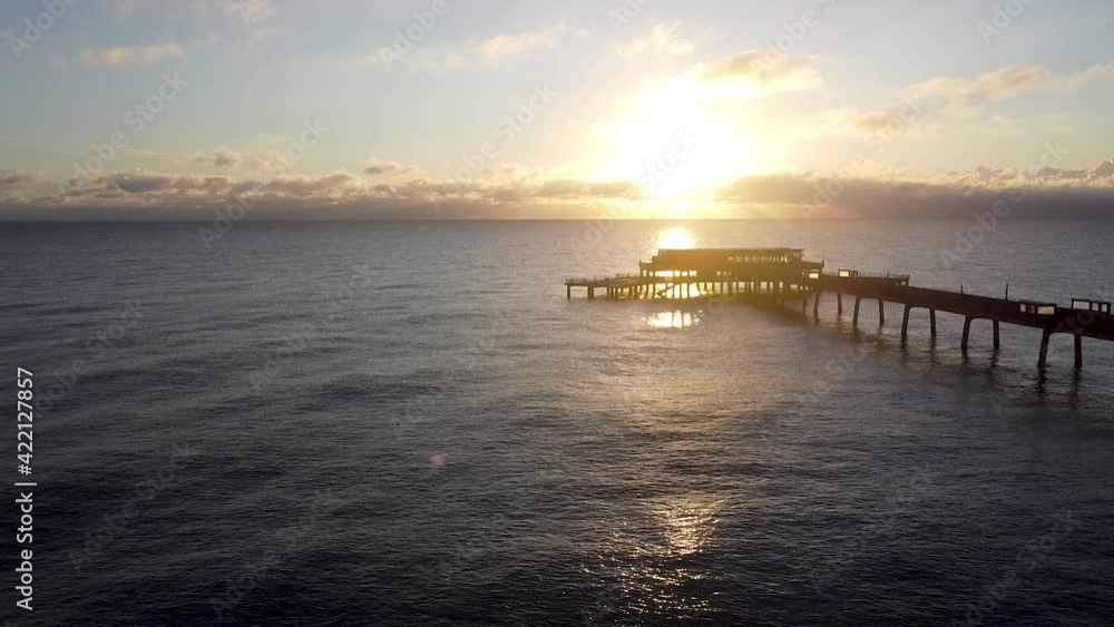 Beautiful warm sunrise horizon aerial view above idyllic Deal pier Kent landmark rising pull back Beautiful warm sunrise horizon aerial view above idyllic Deal pier Kent landmark rising pull back
