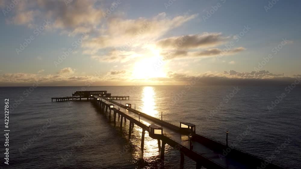 Rising aerial beautiful warm sunrise above Deal pier Kent coastal skyline Rising aerial beautiful warm sunrise above Deal pier Kent coastal skyline