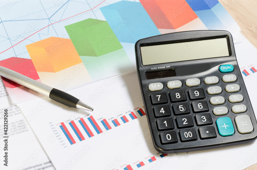 Accounting business concept. Close-up calculator with pen at financial report background. Accounting business concept. Close-up calculator with pen at financial report background.