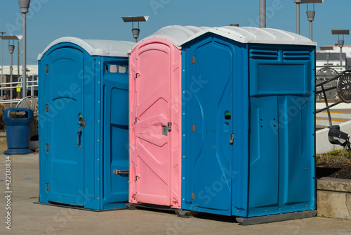 row of public portable mobile toilets on the street outdoor