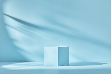 Blue background for product presentation with shadows and light. Empty cubic podium. Mockup.