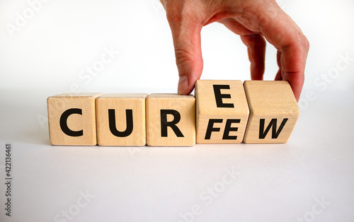 Curfew and cure symbol. Businessman turns cubes and changes the word 'curfew' to 'cure'. Beautiful white background. Business, curfew and cure concept. Copy space.