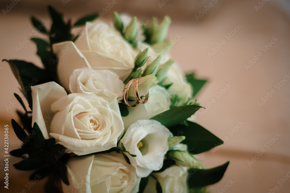 Close-up image of the bride's bouquet and wedding rings on it with blur. Close-up image of the bride's bouquet and wedding rings on it with blur.