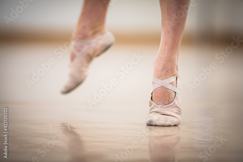 Legs and slippers of classical ballet dancers rehearsing © lightpoet