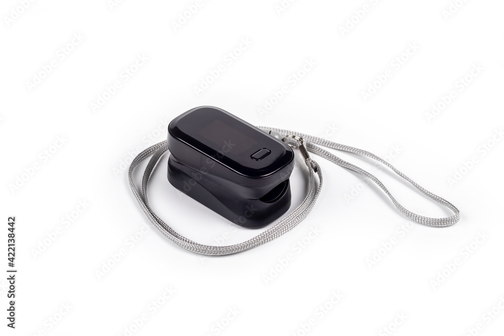 Portable black pulse oximeter on a white background. Monitoring the oxygen level at home. Covid-19, a heart rate health tester is used to measure the air in the lungs. Portable black pulse oximeter on a white background. Monitoring the oxygen level at home. Covid-19, a heart rate health tester is used to measure the air in the lungs.
