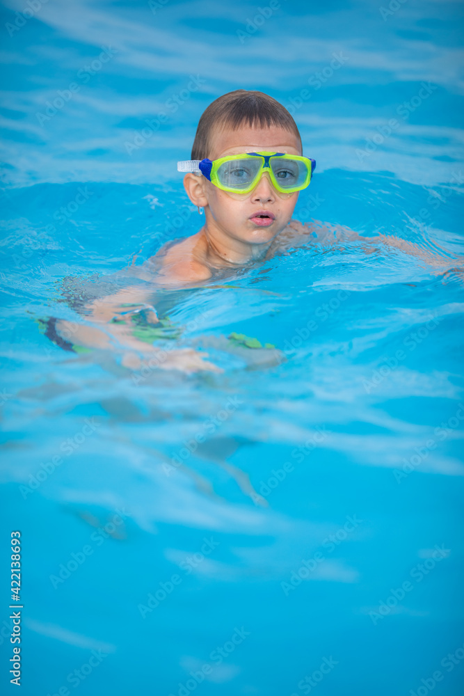Cute little boy in a swimming pool