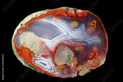 A cross section of the agate stone. Many inclusions, quartz and chalcedony lamination occurs. Origin: Rudno near Krakow, Poland.