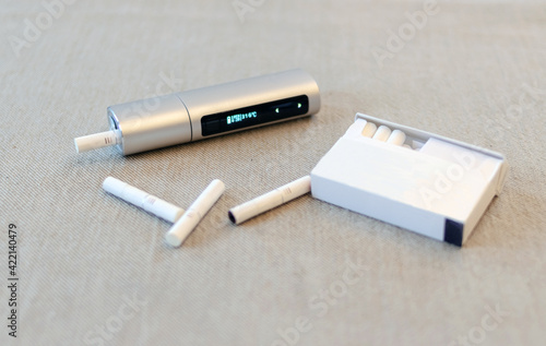 E-Cigs. System for tobacco. Close-up. Electric hybrid cigarette with heating pad, tobacco heating system.