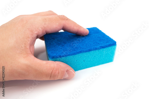 Close-up of kitchen sponge in hand on white