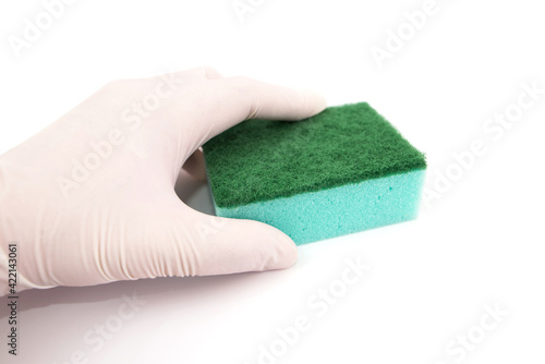 hand in glove holds kitchen sponge isolated on white