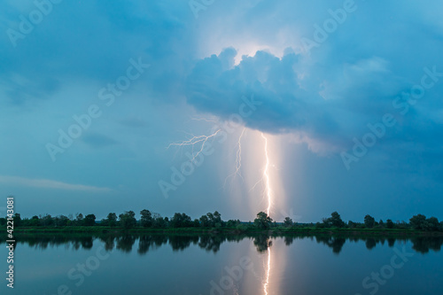 Obraz na płótnie Bright flash of lightning over the river w salonie
