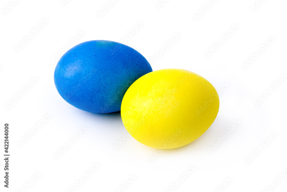 Two chicken eggs painted in yellow and blue colors on a white background Two chicken eggs painted in yellow and blue colors on a white background